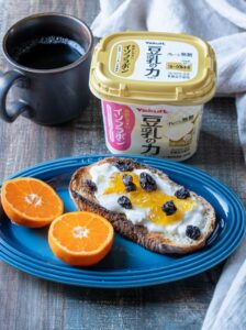 豆乳ヨーグルトをパンにつけている画像